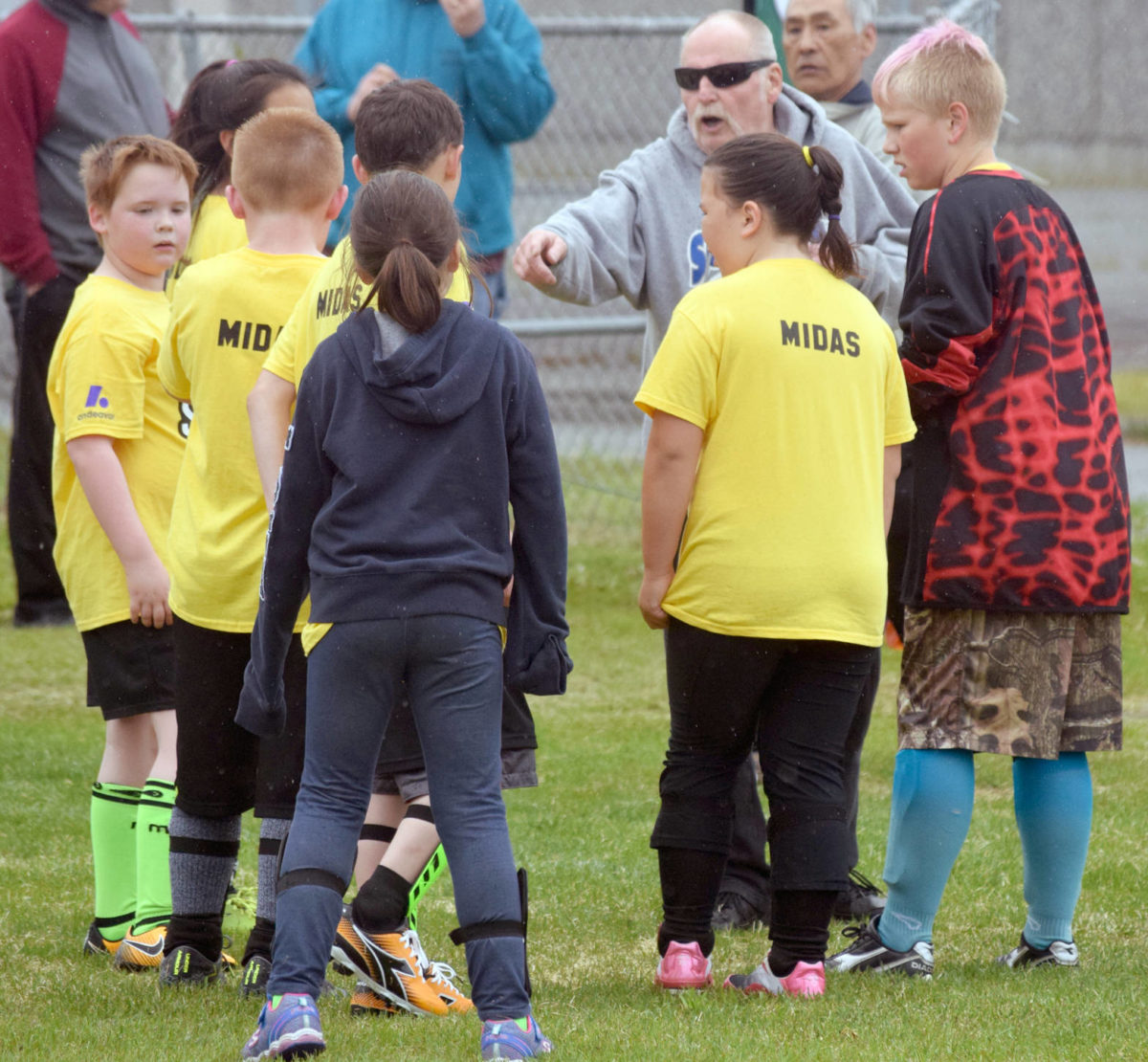 Horst Haunold, of Soldotna, coaches his team Tuesday, June 19, 2018, at Boys and Girls Club soccer at Kenai Middle School. (Photo by Jeff Helminiak/Peninsula Clarion)