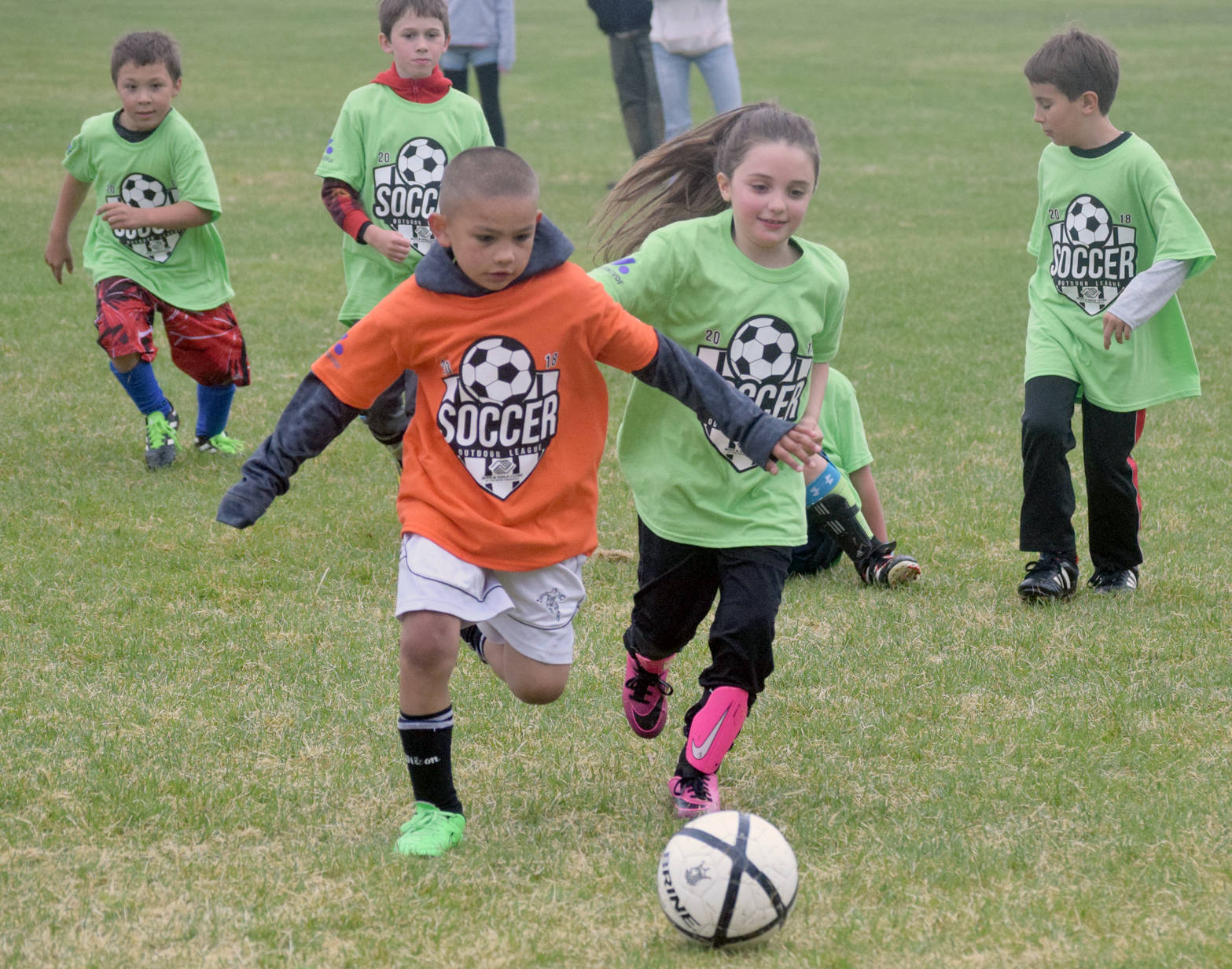 Christian Ray and Sophia Sturm battle for the ball Tuesday, June 19, 2018, at Boys and Girls Club soccer at Kenai Middle School. (Photo by Jeff Helminiak/Peninsula Clarion)