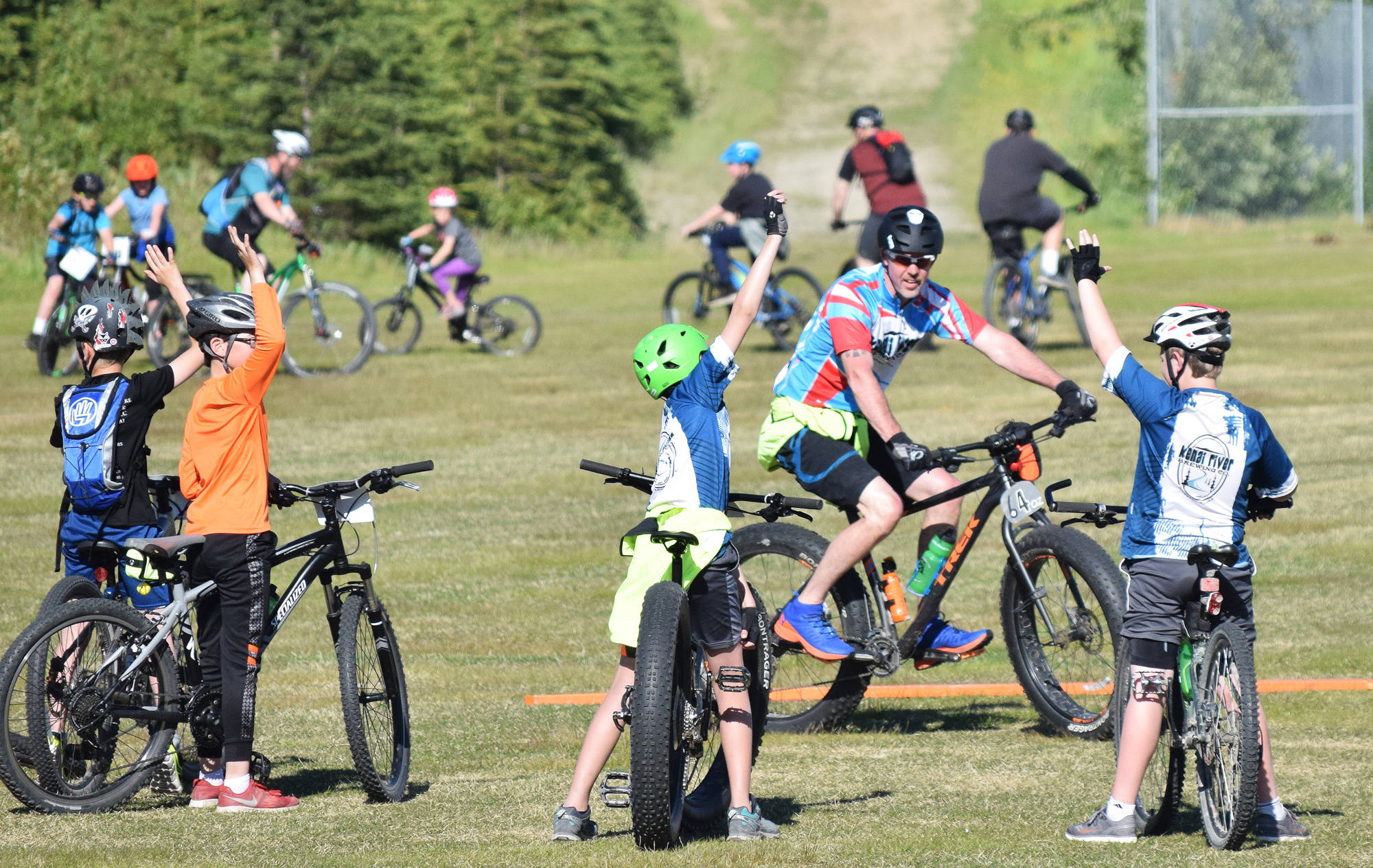 Tsalteshi Sprockets volunteer coach Rob Carson teaches a group of youth riders Thursday, June 14, at the Tsalteshi Trails in Soldotna. (Photo by Joey Klecka/Peninsula Clarion)