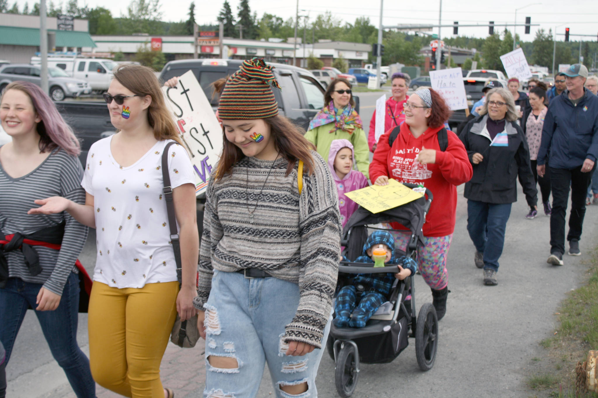 Participants in the Two Spirit Pride March walk along the Sterling Highway on their way to Soldotna Creek Park Wednesday. About 60 people turned out to the march celebrating LGBTQ Pride. (Photo by Erin Thompson/Peninsula Clarion)