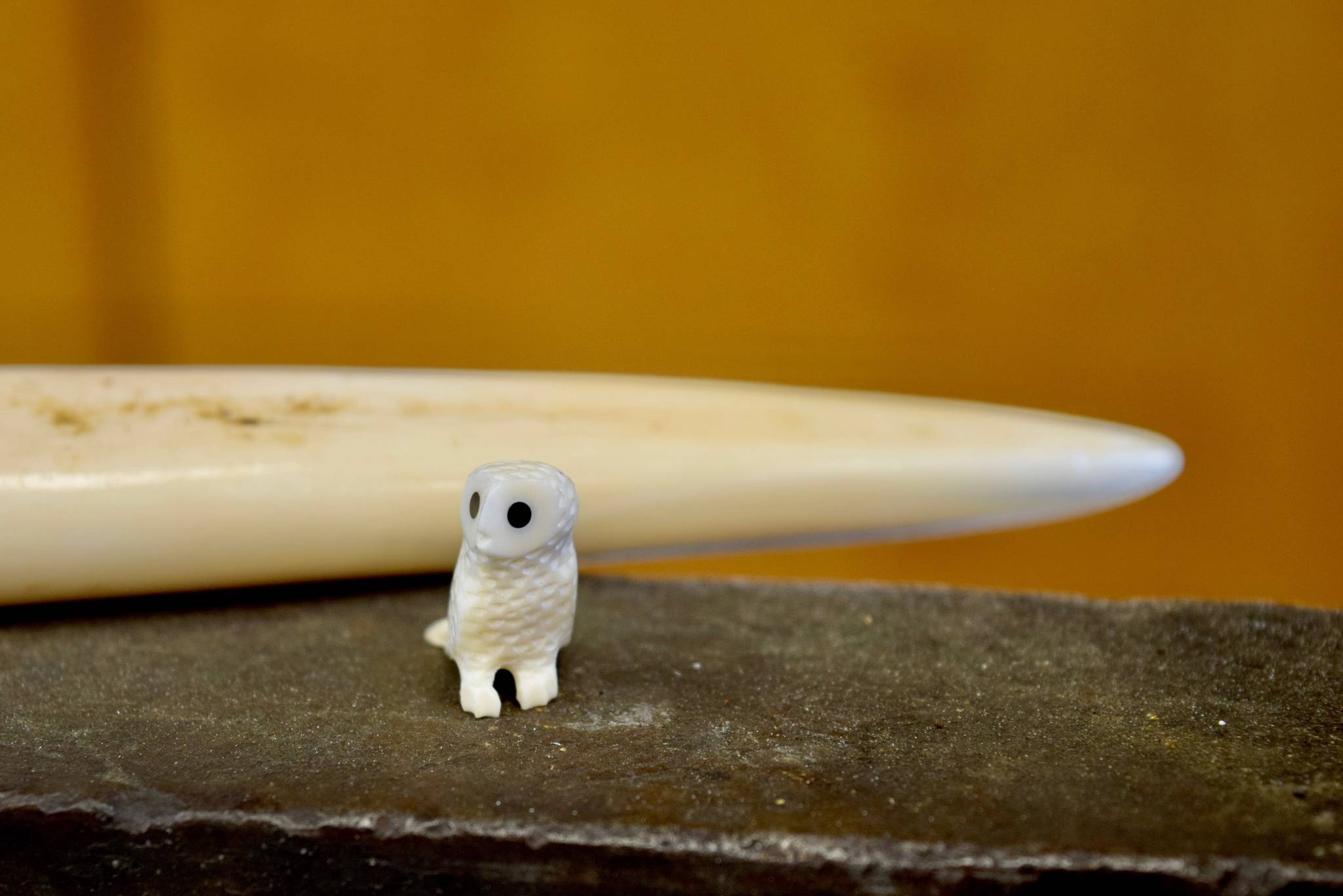 An ivory owl figurine made by Sam Schimmel is used as an example during his ivory carving demonstration at the first workshop of the Kenai National Wildlife Refuge’s cultural heritage series on Friday, July 6, at the Kenai National Wildlife Refuge Visitors Center, near Soldotna, Alaska. (Photo by Victoria Petersen/Peninsula Clarion)