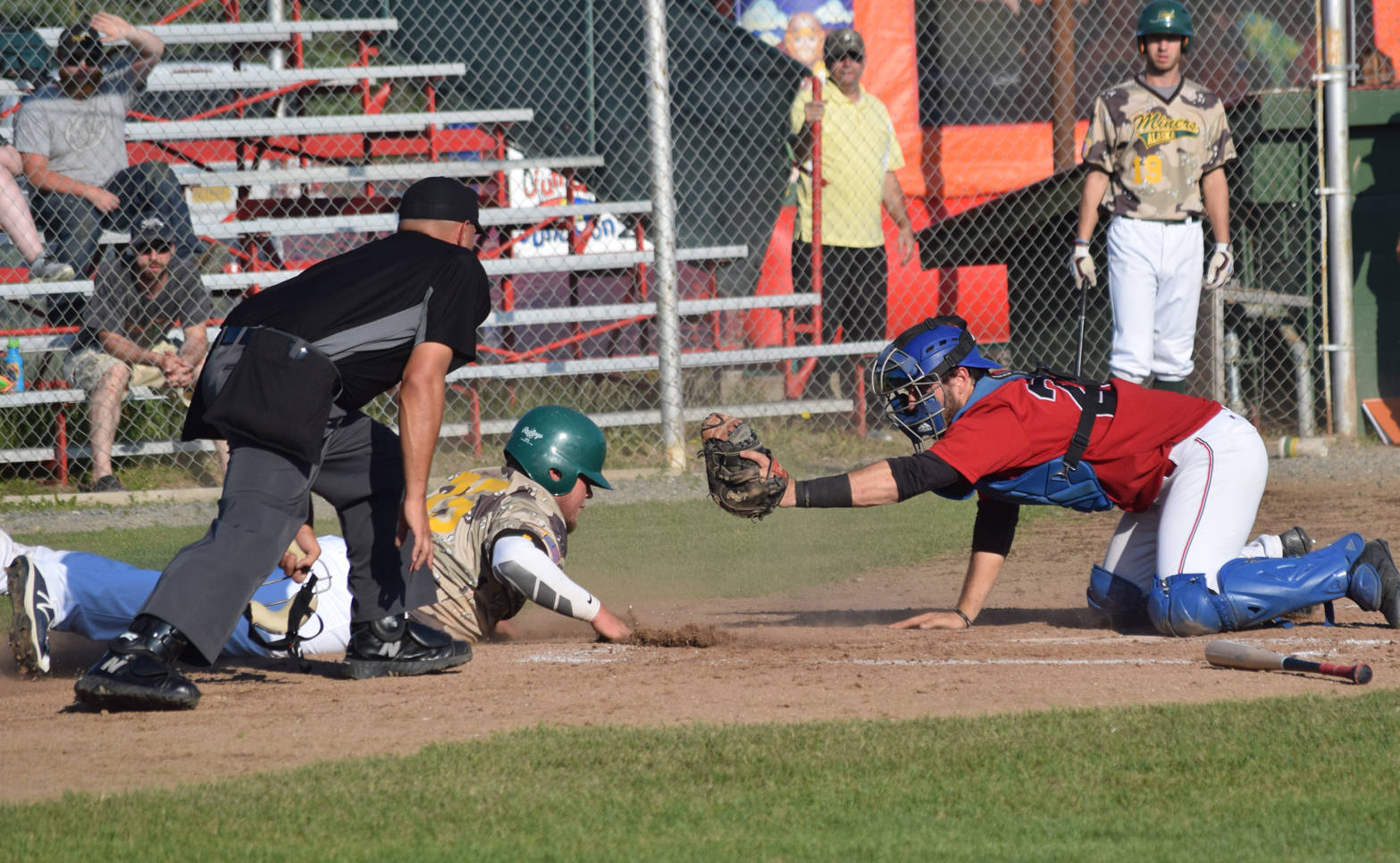 Oilers catcher Ryan Koch tags out Spencer Henson of the Miners in the third inning Friday, July 6, 2018, at Coral Seymour Memorial Park in Kenai. (Photo by Jeff Helminiak/Peninsula Clarion)