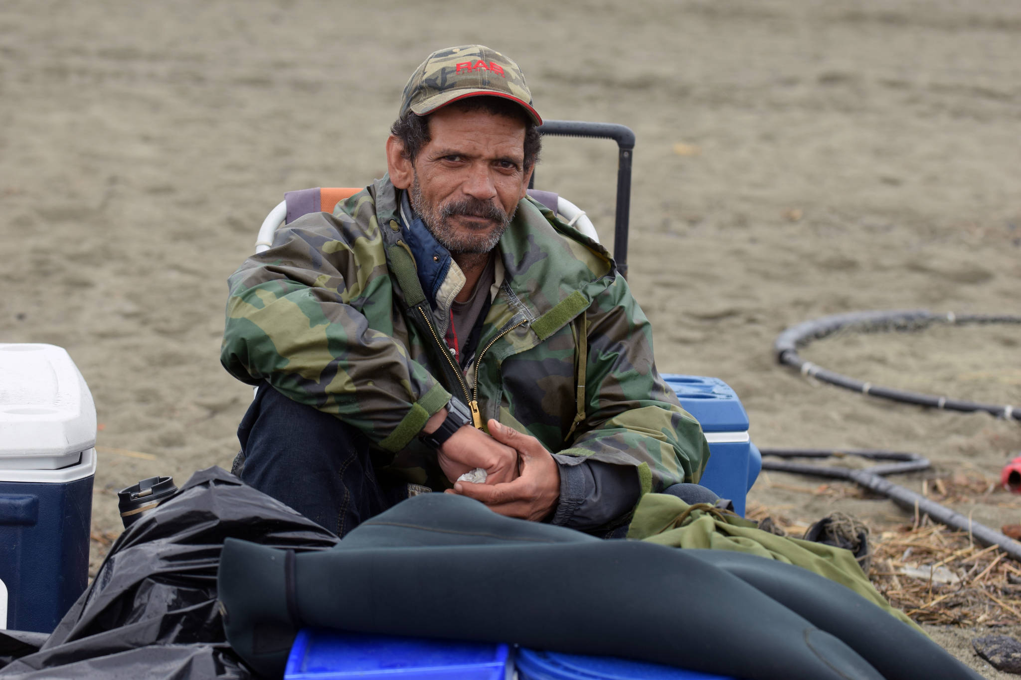 Anchorage resident Mike Wolford rests on Kenai Beach Tuesday, June 10, 2018, during the first day of dipnetting season in Kenai, Alaska. Wolford, who traveled with a friend to join in the dipnetters, had caught on salmon by mid-afternoon. (Photo by Erin Thompson/Peninsula Clarion)