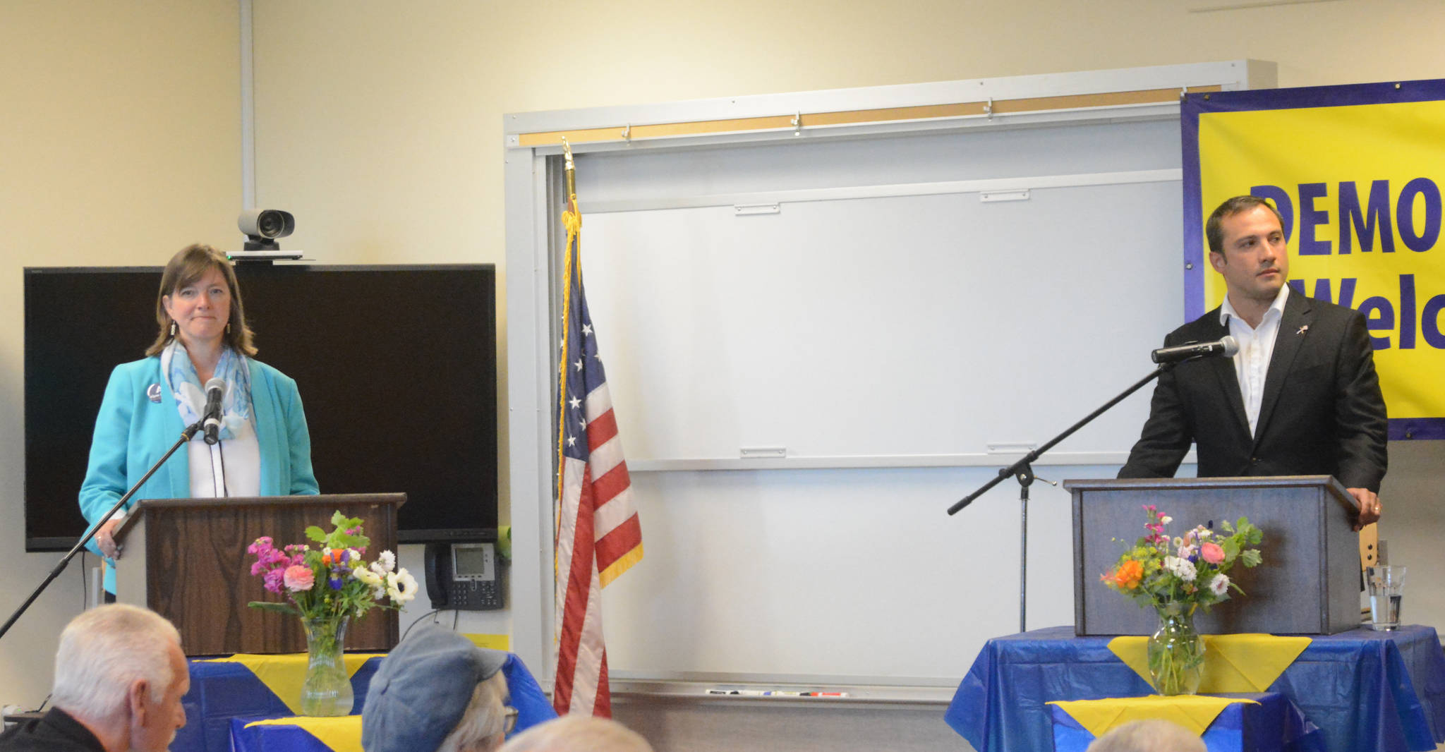 Alyse Galvin, left, and Dimitri Shein, right, listen to a question from moderator Kelly Cooper at the start of the debate among the candidates for the Democratic Party nomination for U.S. Congress on Tuesday, July 10, 2018 at Kachemak Bay Campus in Homer, Alaska. (Photo by Michael Armstrong/Homer News)