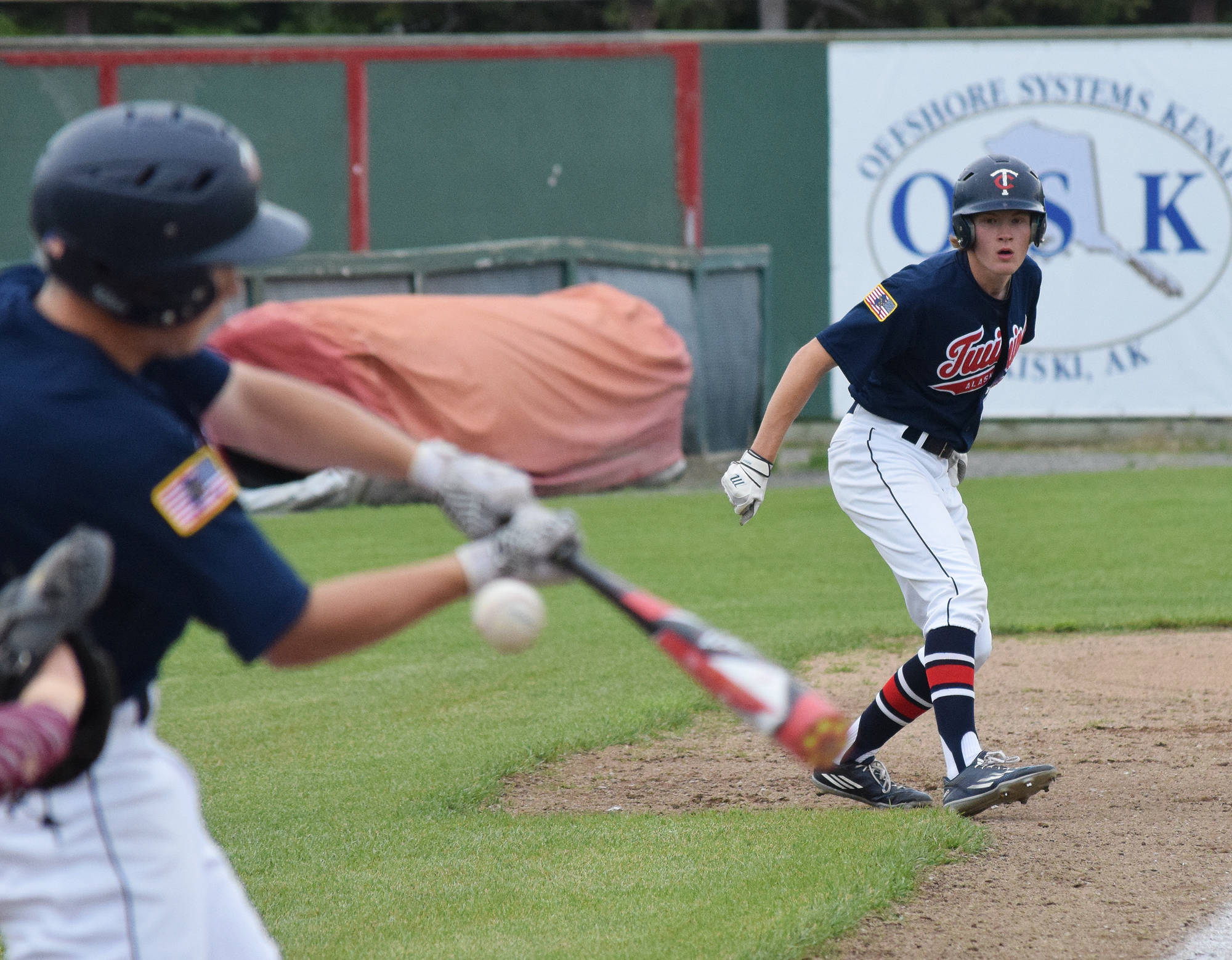 Jeremy Kupferschmid eyes teammate Harrison Metz at the plate Friday afternoon against Dimond at Coral Seymour Memorial Ballpark. (Photo by Joey Klecka/Peninsula Clarion)