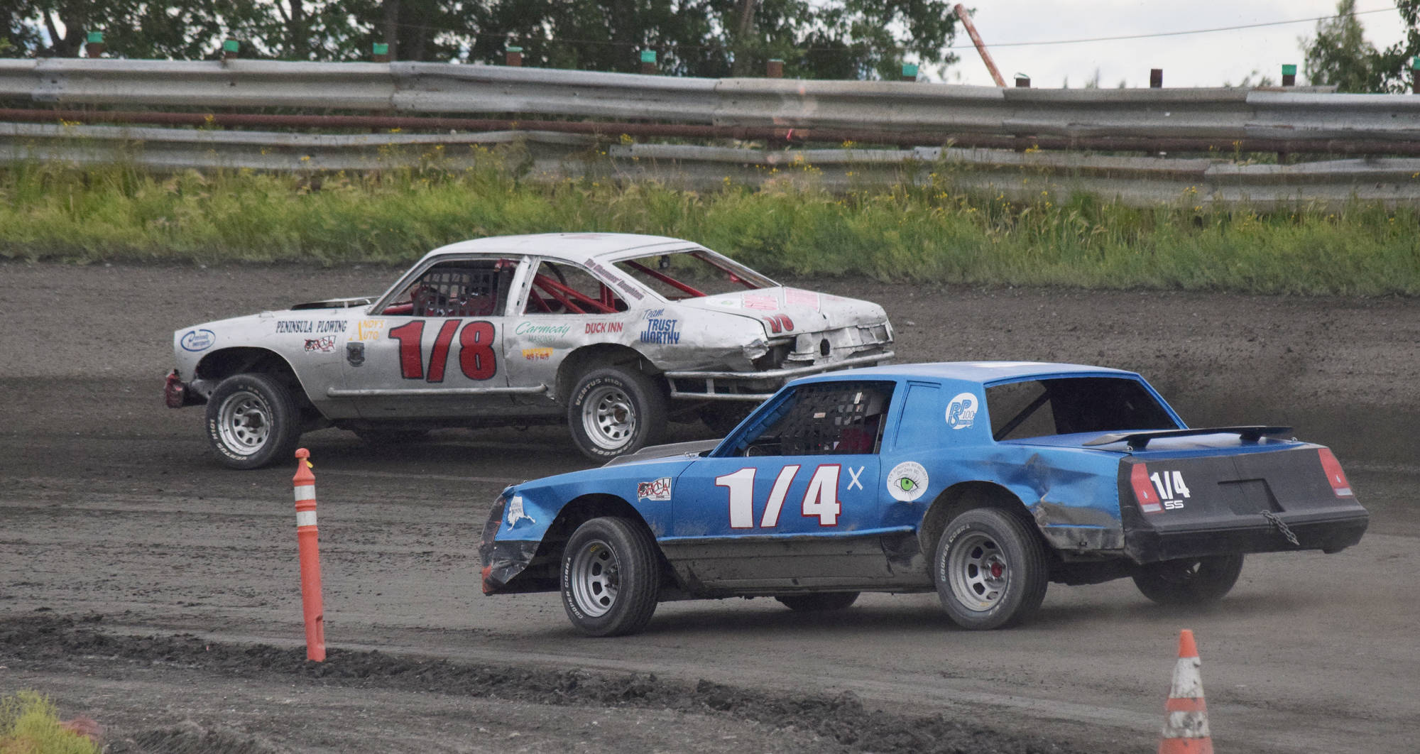 Chris Endsley (1/8) holds off Damian LaMountain (1/4) in the A-Stock feature race Saturday night at Twin City Raceway in Kenai. (Photo by Joey Klecka/Peninsula Clarion)