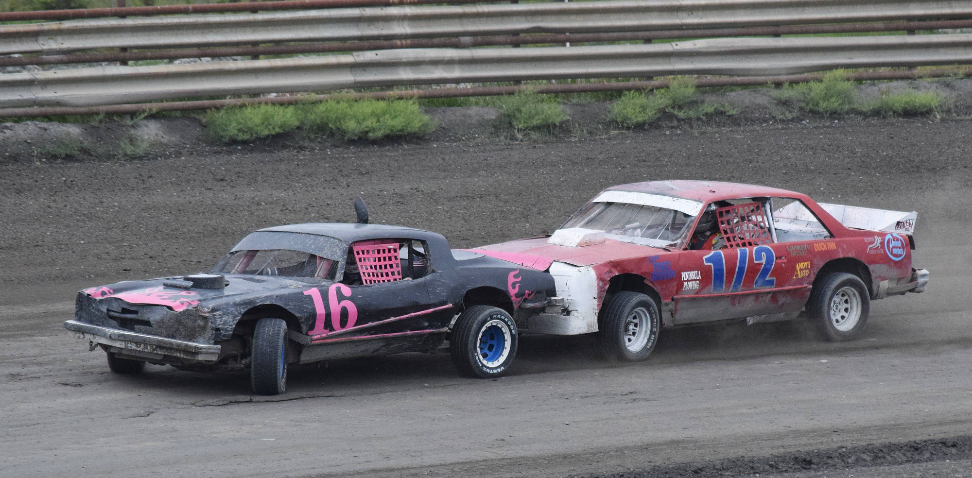 Sean Endsley (right) puts the bumper to Gracie Bass (16) in an A-Stock heat race Saturday night at Twin City Raceway in Kenai. (Photo by Joey Klecka/Peninsula Clarion)