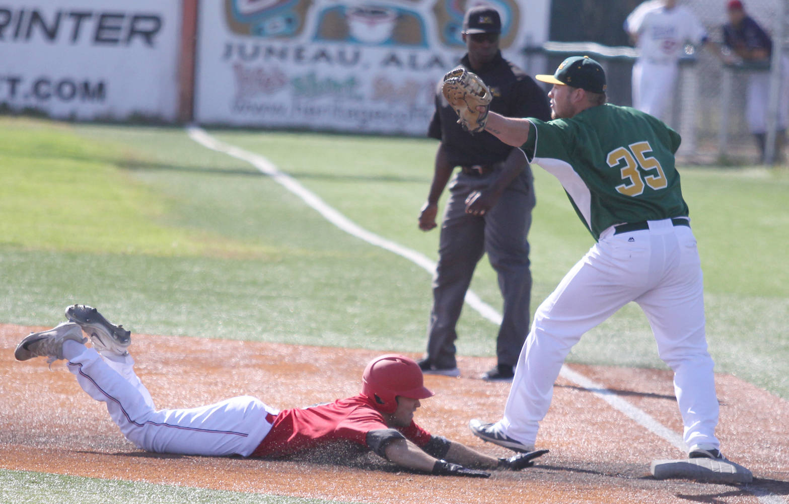 Peninsula Oilers infielder Paul Kunst gets caught at first in a double play during the Alaska Baseball League All-Star Game Sunday afternoon at Mulcahy Stadium in Anchorage. Kunst and the American League beat the National League 7-5. (Photo by Jeremiah Bartz/Frontiersman.com)