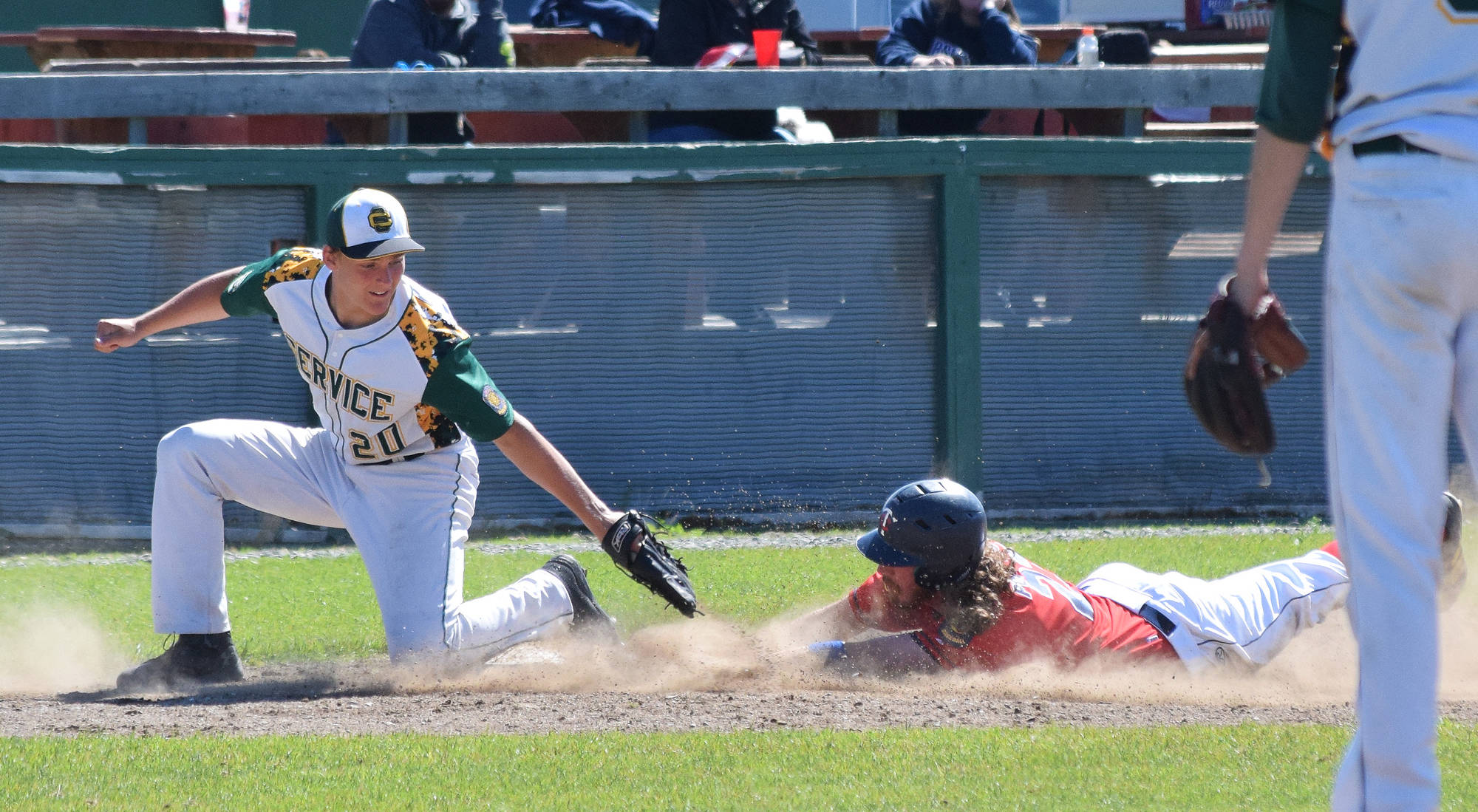 Service third baseman Henry Helgeson (20) loses the ball while attempting to tag Twins baserunner David Michael, Tuesday afternoon at Coral Seymour Memorial Ballpark in Kenai. (Photo by Joey Klecka/Peninsula Clarion)