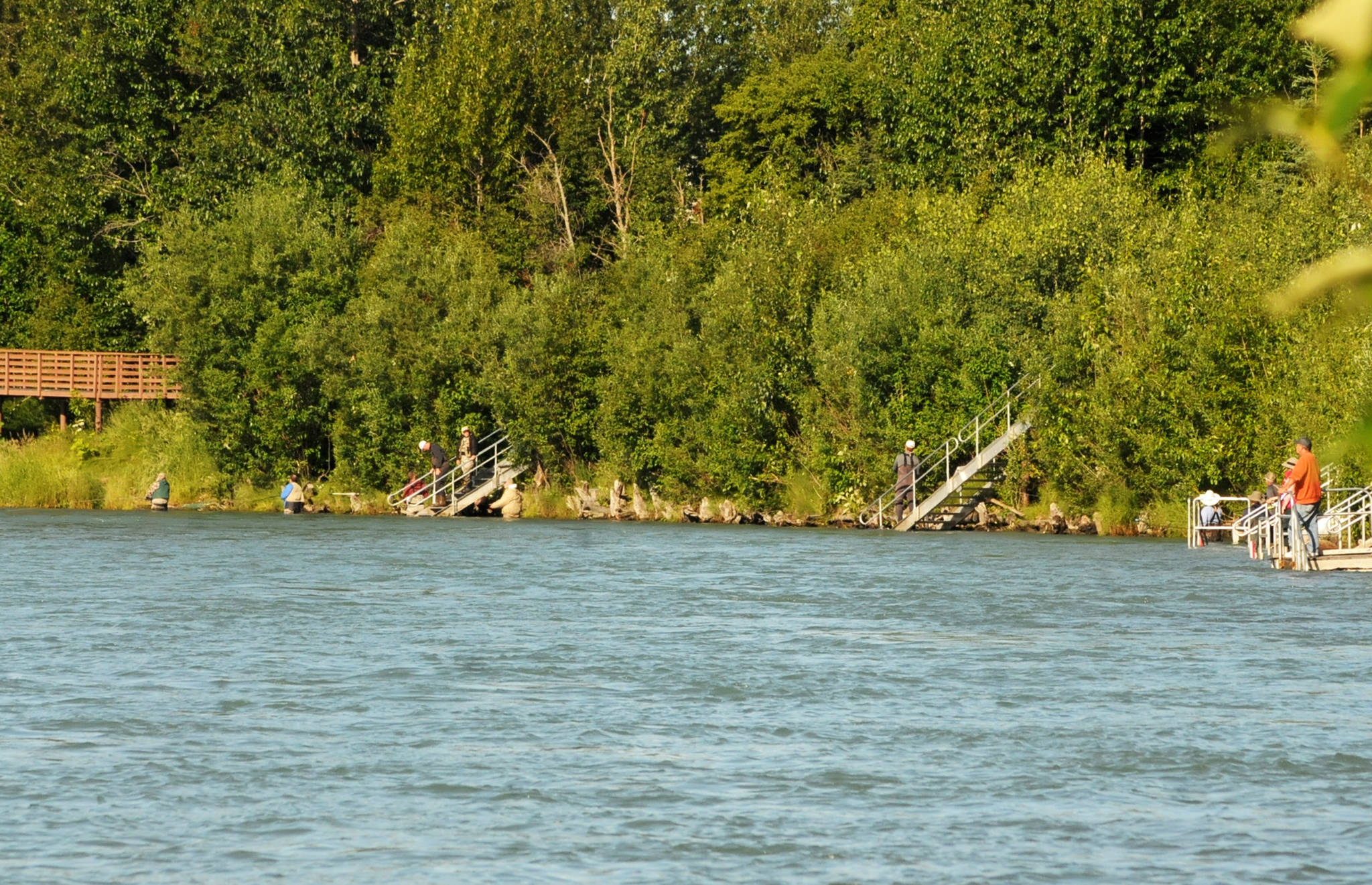 Anglers cast their lines into the Kenai River near Soldotna Creek Park on Wednesday, July 18, 2018 in Soldotna, Alaska. The water in the Kenai River is a little higher than usual — about 9.71 feet, according to U.S. Geological Survey’s gauge at Soldotna — but has fallen since last week and is significantly below the flood stage of 12 feet. Anglers were hitting the banks on Wednesday morning for sockeye salmon, which normally peak in returning numbers to the Kenai River in mid-July. (Photo by Elizabeth Earl/Peninsula Clarion)