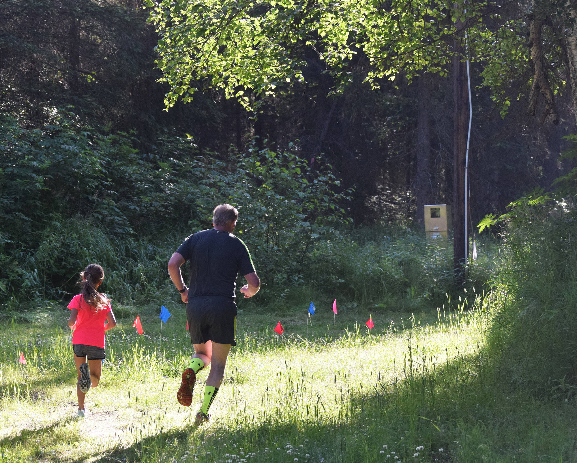 A pair of runners race through the woods Saturday morning in the 10-kilometer race at the Soldotna Rotary Run at the Tsalteshi Trails. (Photo by Joey Klecka/Peninsula Clarion)