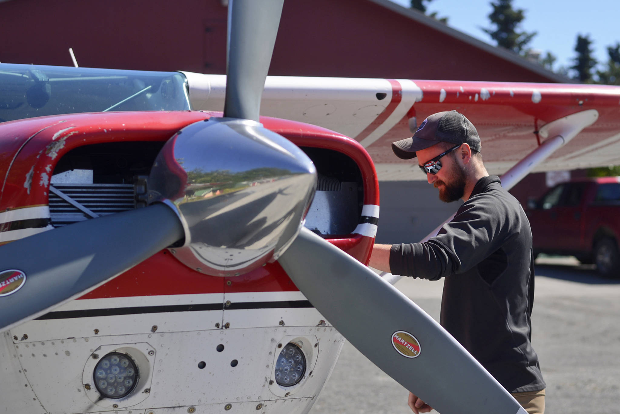 Pilot Alex Agosti inspects Kenai Aviation’s Cessna 206 before a flight with Kenai Aviation owner Joel Caldwell on Tuesday, July 17, 2018 at the Kenai Municipal Airport in Kenai, Alaska. The family-owned aviation business flew passengers and cargo around the Cook Inlet region for 56 years before closing in September 2017 after the Cook Inlet oil field operators who were its primary customers consolidated and dropped investment in response to low oil prices. Caldwell bought the business early this year from Jim Bielefeld, son of founder Bob Bielefeld. Calwell plans to revive and expand Kenai Aviation into a statewide charter. Presently he and two other pilots — Agosti and Keith Ham — are offering flightseeing trips. (Ben Boettger/Peninsula Clarion)