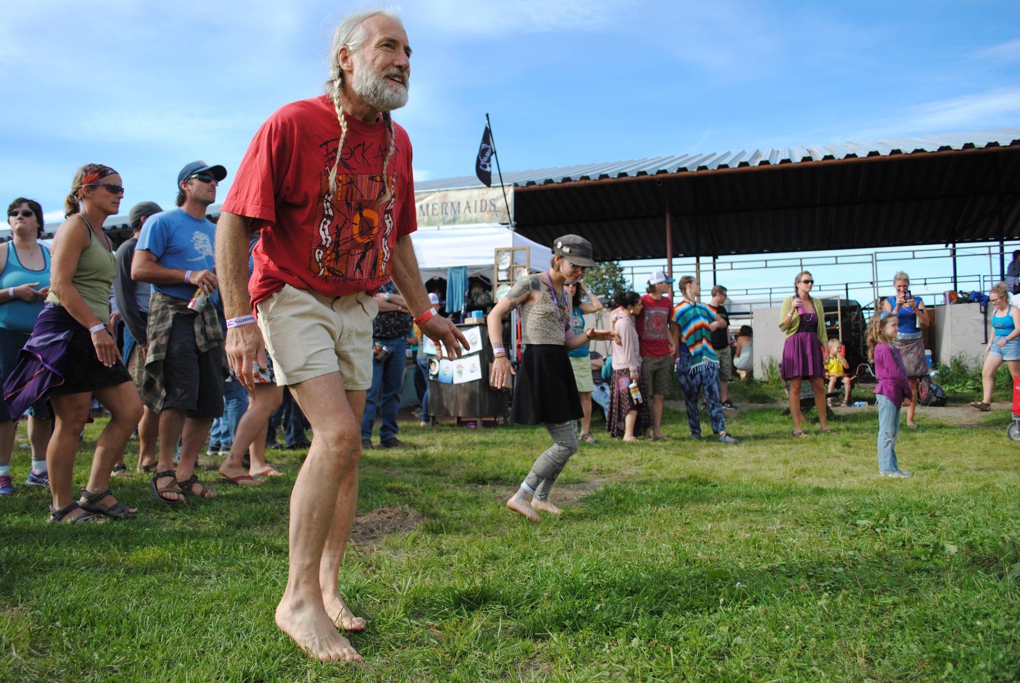 <span class="neFMT neFMT_PhotoCredit">Photo by Kat Sorensen/Peninsula Clarion</span>                                Stu Schmutzler dances at the River Stage during Rabbit Creek Ramblers’ set at the 2017 Salmonfest in Ninilchik, Alaska on Friday, Aug. 4, 2017.