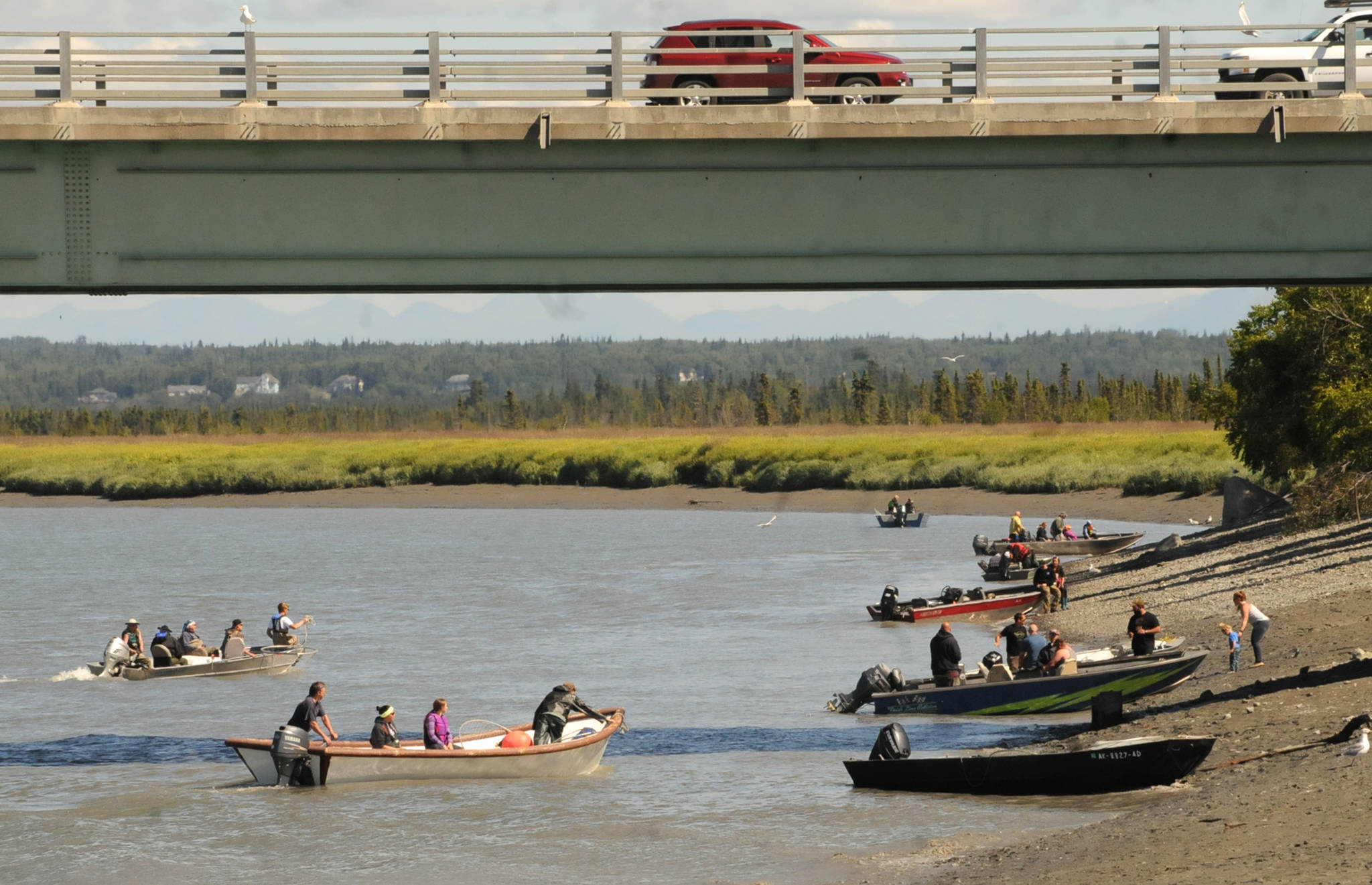 Personal-use dipnet fishermen pull up to the bank of the Kenai River beneath the Warren Ames Bridge on Saturday, July 21, 2018 in Kenai, Alaska. (Photo by Elizabeth Earl/Peninsula Clarion)