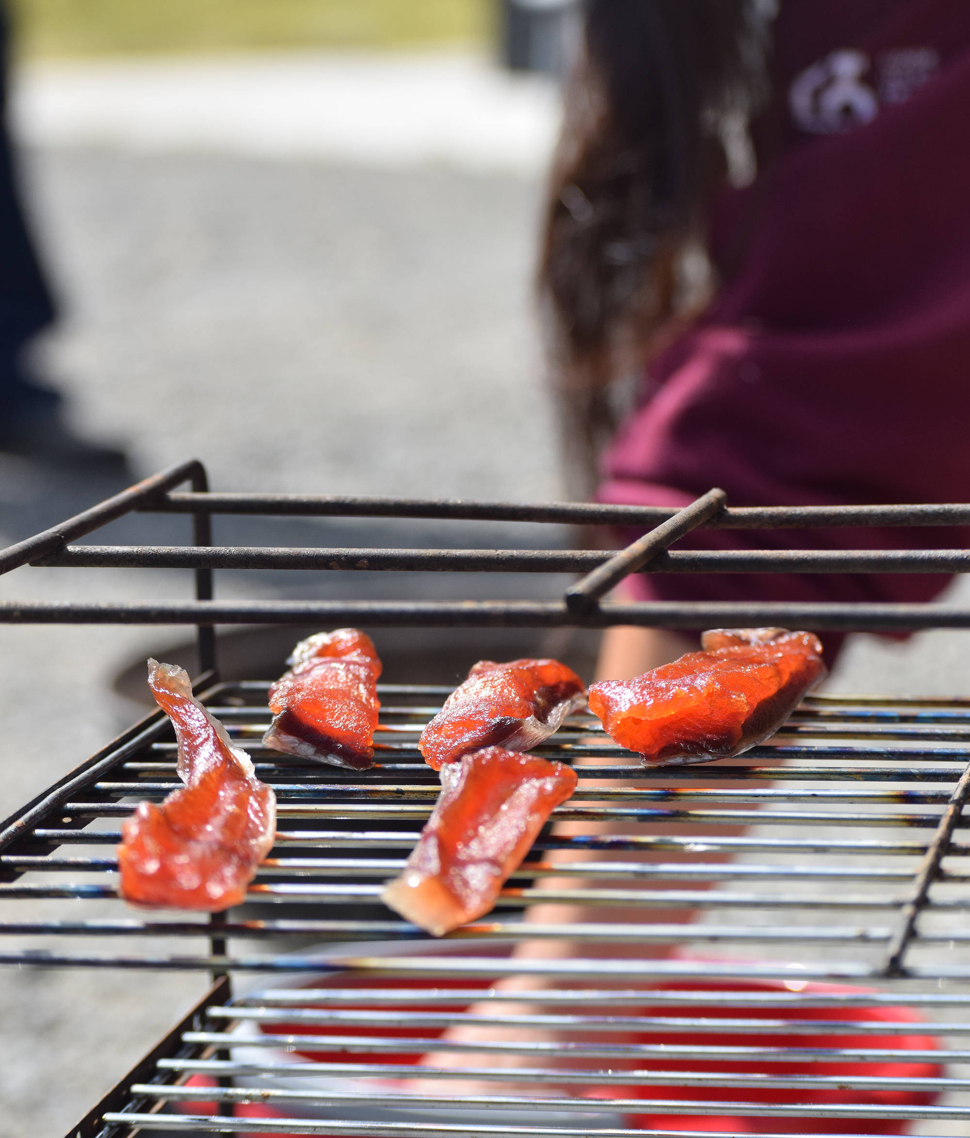 Smoked salmons strips sit on a drying rack in a fish smoking demonstration July 20, 2018, at the Kenai National Wildlife Refuge. (Photo by Joey Klecka/Peninsula Clarion)