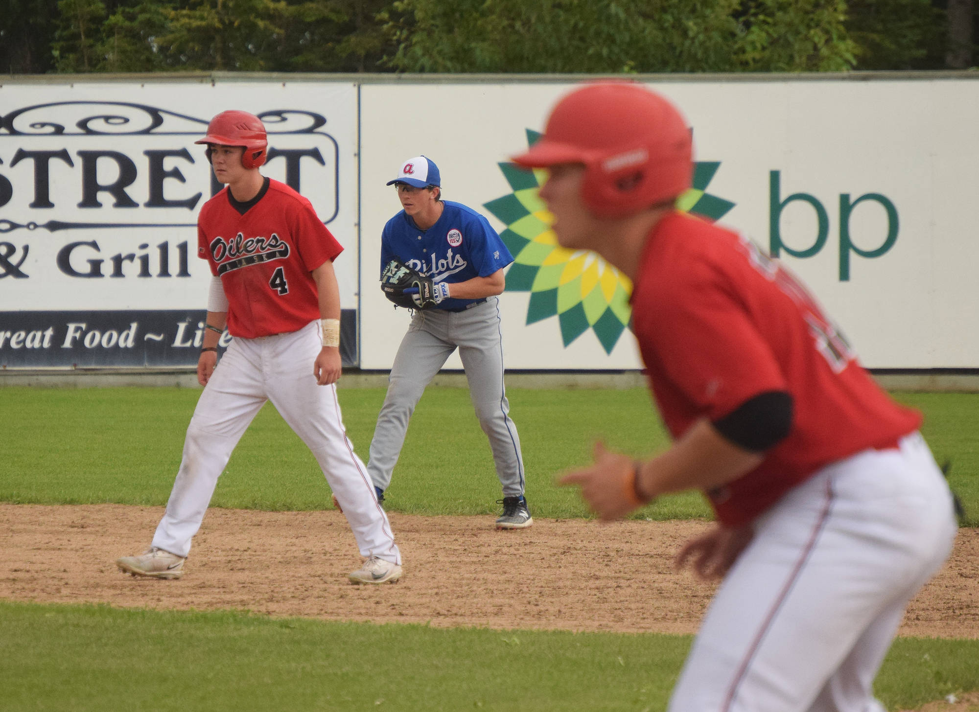 Bryce Begell (4) and Peninsula Oilers teammate Zack Zalesky take their leads off the bases Thursday against the Anchorage Glacier Pilots at Coral Seymour Memorial Ballpark in Kenai. (Photo by Joey Klecka/Peninsula Clarion)