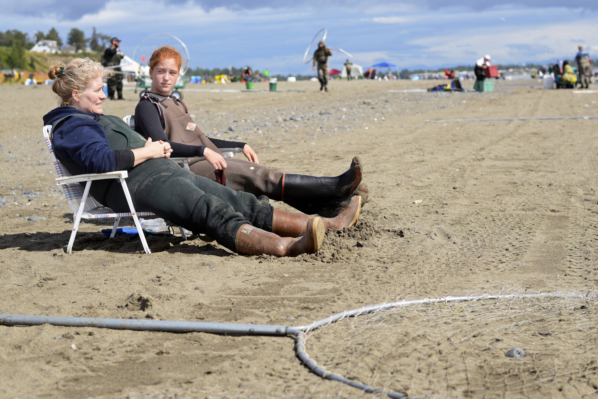 Tiffany Musgrave (left) and daughter McCady Musgrave take a break from dipnetting on Kenai’s north beach on Thursday, July 26, 2018 in Kenai, Alaska. Tiffany Musgrave said the family had caught two salmon that day and four the previous day, making this year’s dipnet one of the worst she remembered — one year, she recalled, she and her husband had caught 64 fish in four hours on Kenai’s south beach. (Ben Boettger/Peninsula Clarion)