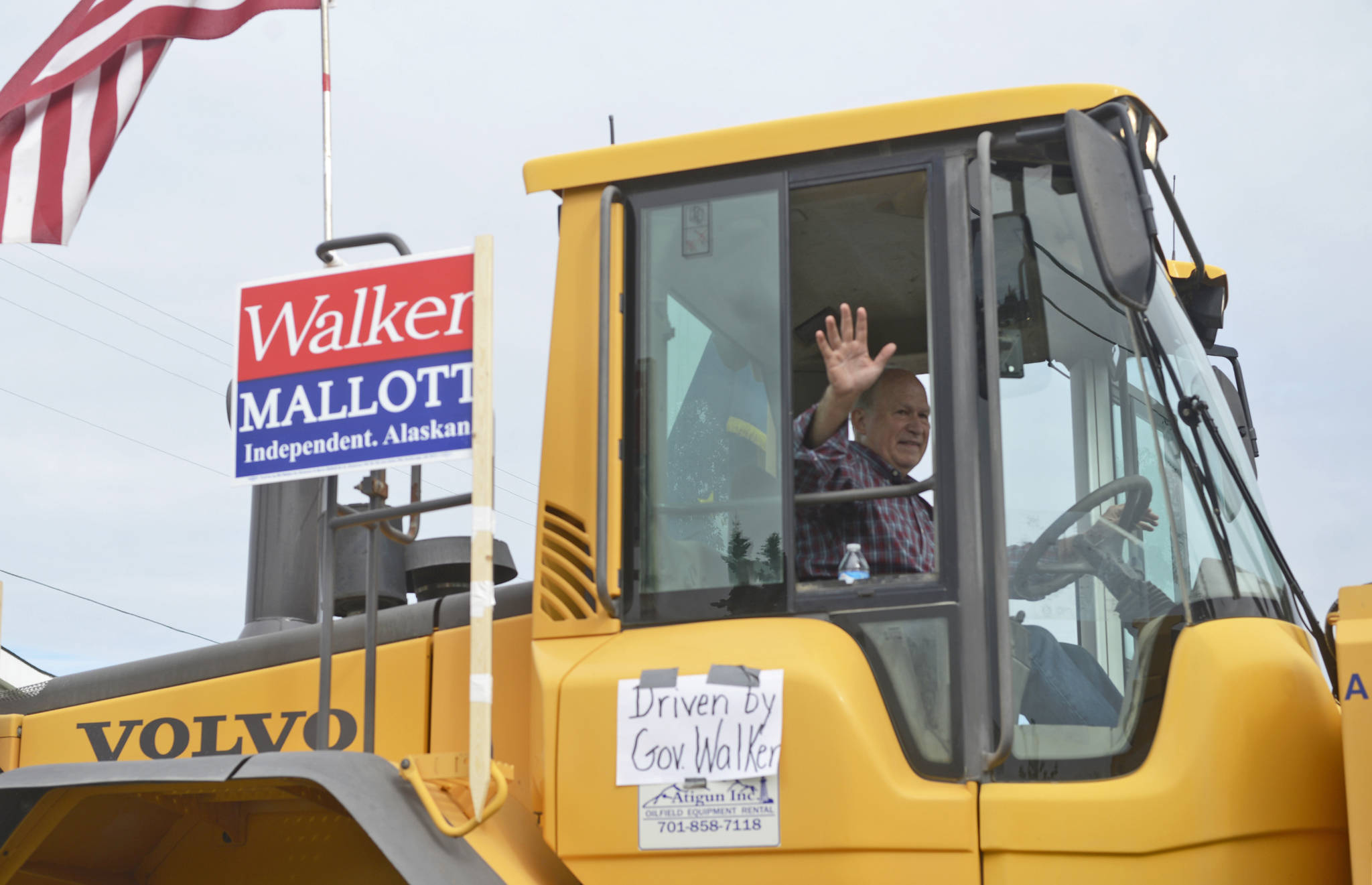 Gov. Bill Walker drives a tractor part of his gubernatorial reelection campaign float in the Progress Days parade down Marydale Avenue on Saturday, July 28, 2018 in Soldotna, Alaska. The parade kicks off the weekend-long event celebrating Soldotna’s history, with a market on Saturday and Sunday in Soldotna Creek Park and a concert Saturday night followed by a free community barbecue Sunday. (Photo by Elizabeth Earl/Peninsula Clarion)