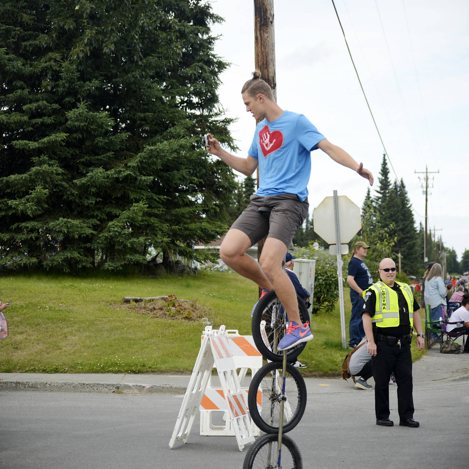 Josiah Martin of Soldotna deftly perches atop a unicycle during the Progress Days parade on Saturday, July 28, 2018 in Soldotna, Alaska. The parade kicks off the weekend-long event celebrating Soldotna’s history, with a market on Saturday and Sunday in Soldotna Creek Park and a concert Saturday night followed by a free community barbecue Sunday. (Photo by Elizabeth Earl/Peninsula Clarion)