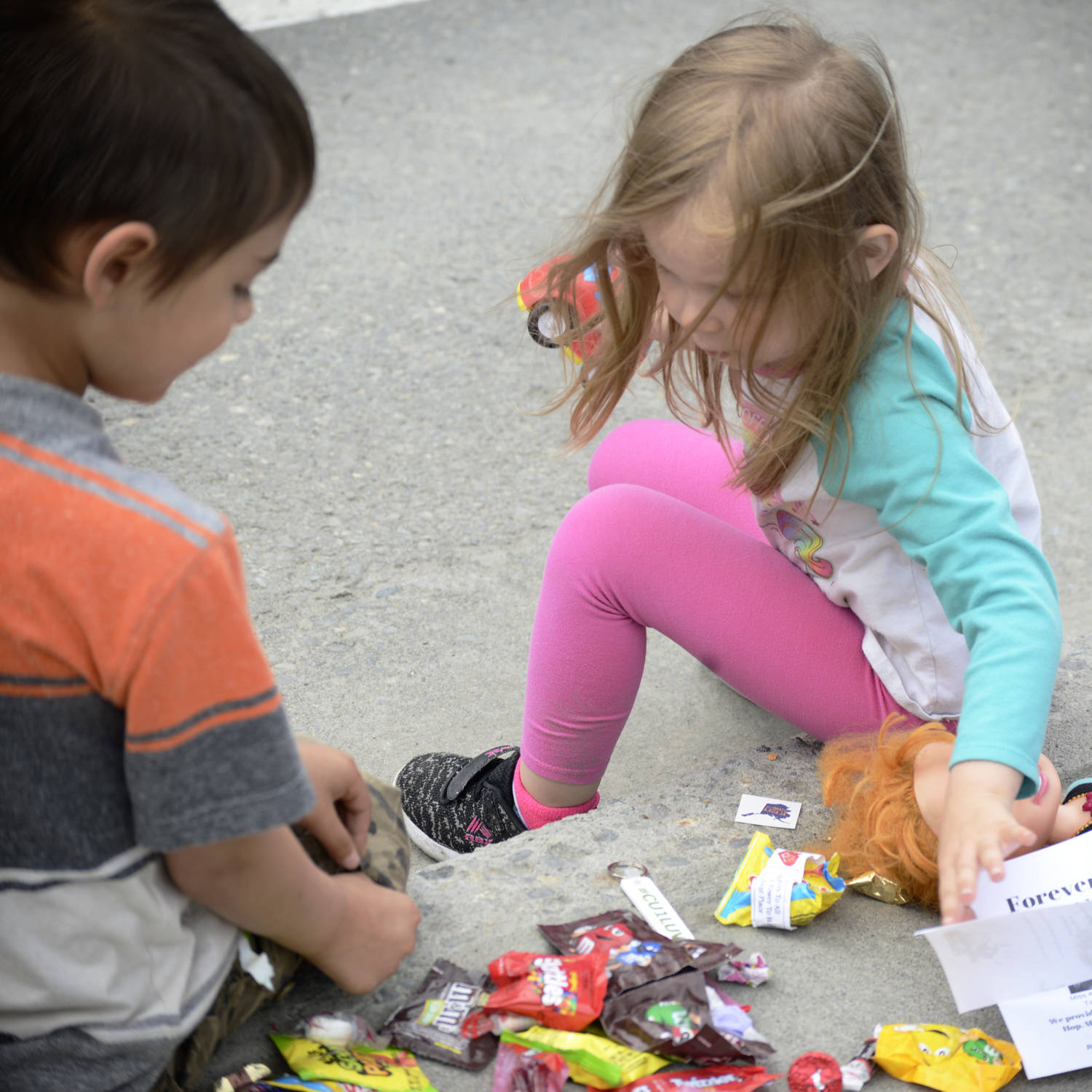 Ian Garay, 7, (left) and Stephanie Daigle, 3, (right), take stock of their candy stash collected from the Progress Days parade on Marydale Avenue on Saturday, July 28, 2018 in Soldotna, Alaska. The parade kicks off the weekend-long event celebrating Soldotna’s history, with a market on Saturday and Sunday in Soldotna Creek Park and a concert Saturday night followed by a free community barbecue Sunday. (Photo by Elizabeth Earl/Peninsula Clarion)
