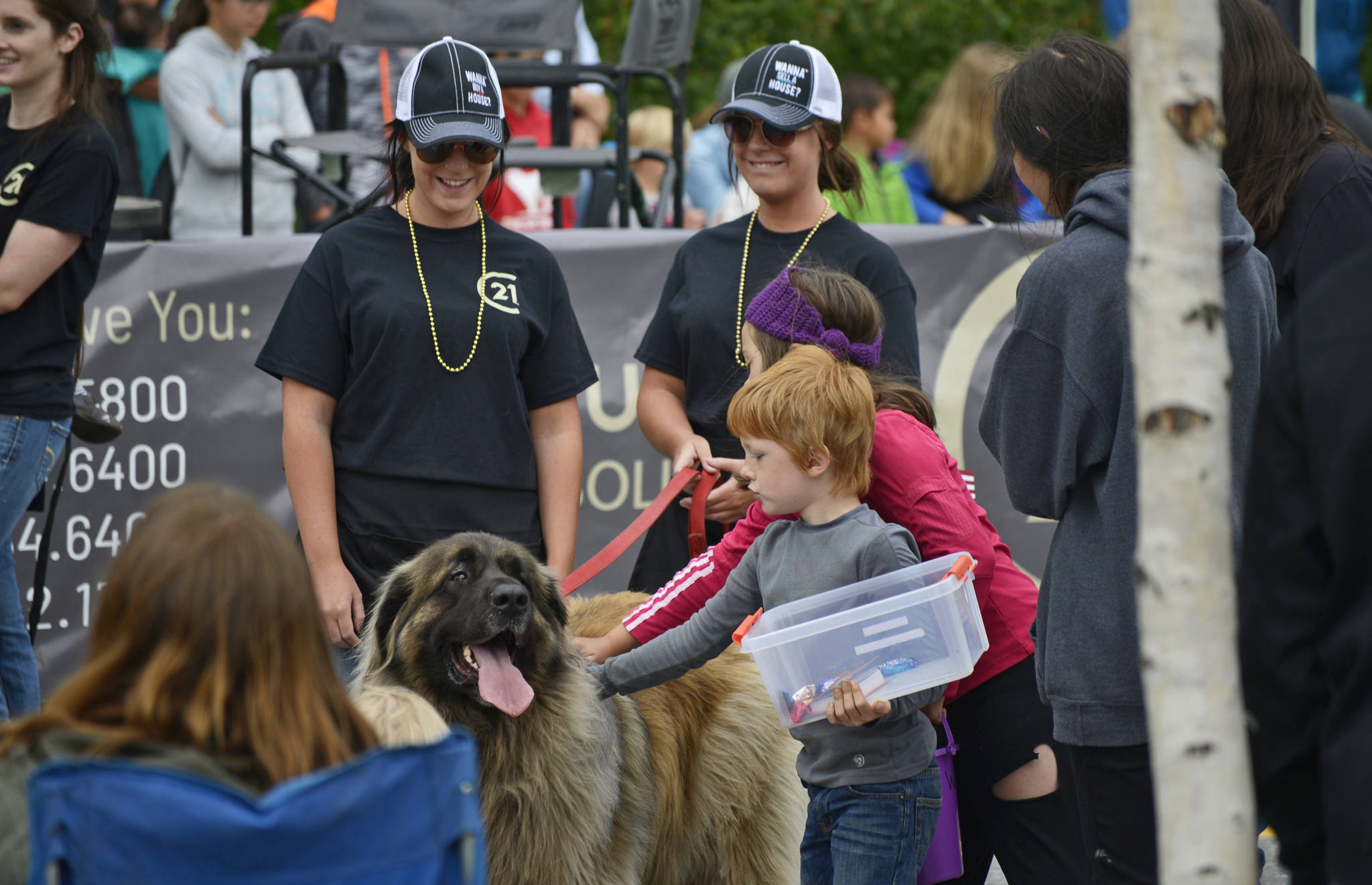 Kids flock to pet a dog with the 21st Century Realty float at the Progress Days parade on Saturday, July 28, 2018 in Soldotna, Alaska. The parade kicks off the weekend-long event celebrating Soldotna’s history, with a market on Saturday and Sunday in Soldotna Creek Park and a concert Saturday night followed by a free community barbecue Sunday. (Photo by Elizabeth Earl/Peninsula Clarion)