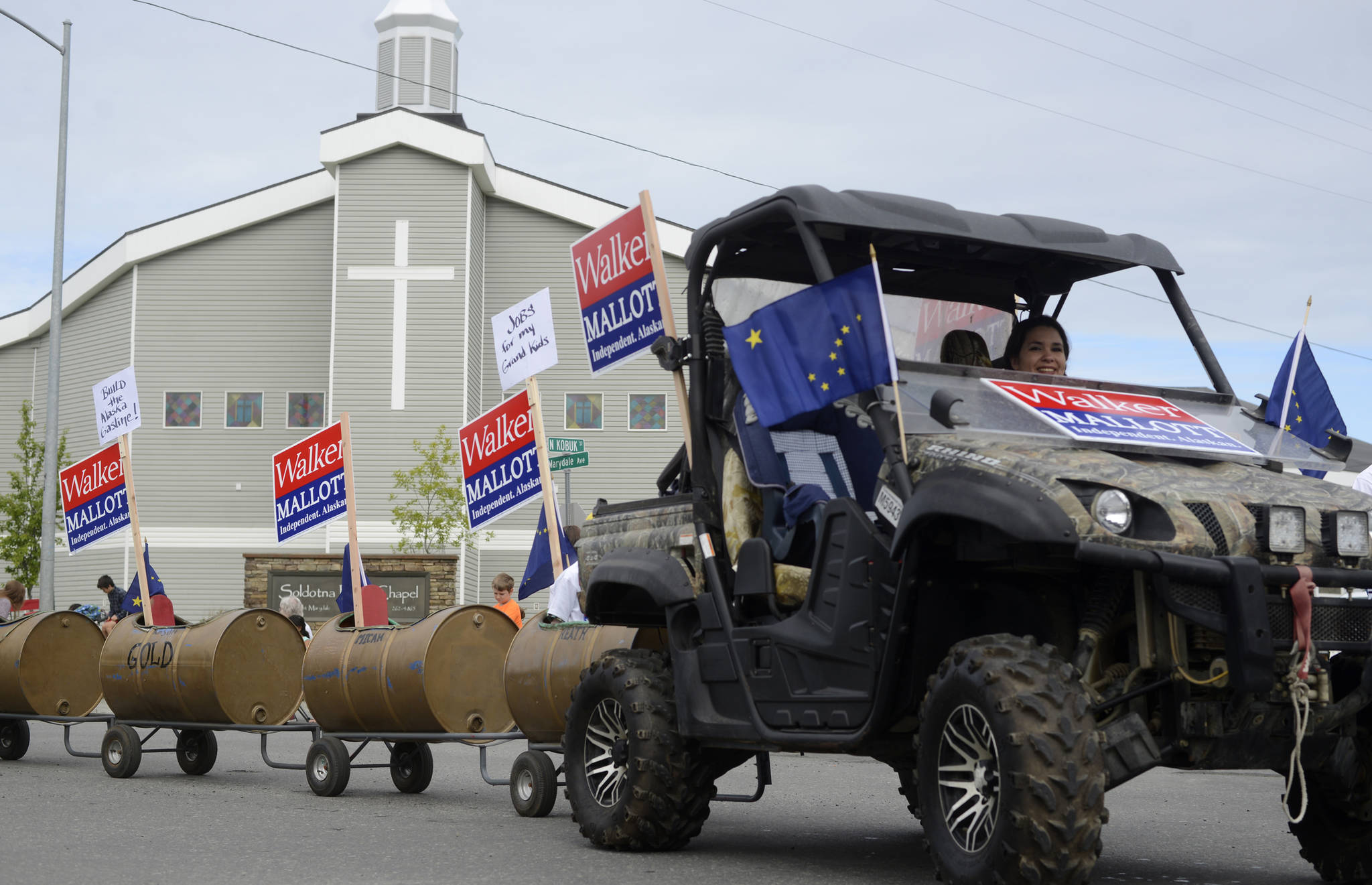 Volunteers for Gov. Bill Walker’s gubernatorial reelection campaign float in the Progress Days parade make their way down Marydale Avenue on Saturday, July 28, 2018 in Soldotna, Alaska. The parade kicks off the weekend-long event celebrating Soldotna’s history, with a market on Saturday and Sunday in Soldotna Creek Park and a concert Saturday night followed by a free community barbecue Sunday. (Photo by Elizabeth Earl/Peninsula Clarion)