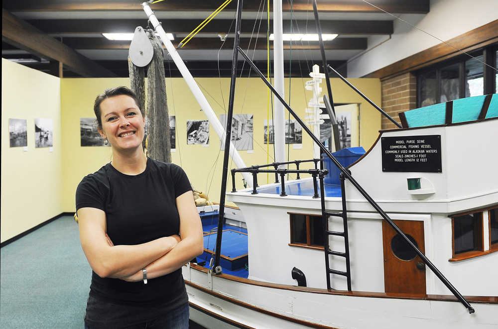 In this Oct. 18, 2013 photo, Lacey Simpson poses for photos in the Tongas Historical Museum in Ketchikan, Alaska. Tongass Historical Museum is soliciting submissions for its new exhibit "First in Fish, Ketchikan's Commercial Fishing Traditions" that will open Feb. 28 and run through the summer tourist season. Simpson said the museum is looking for personal stories, a present day photo, family heirloom, a story about a specific event, or an artifact related to commercial fishing. (AP Photo/Ketchikan Daily News, Hall Anderson)