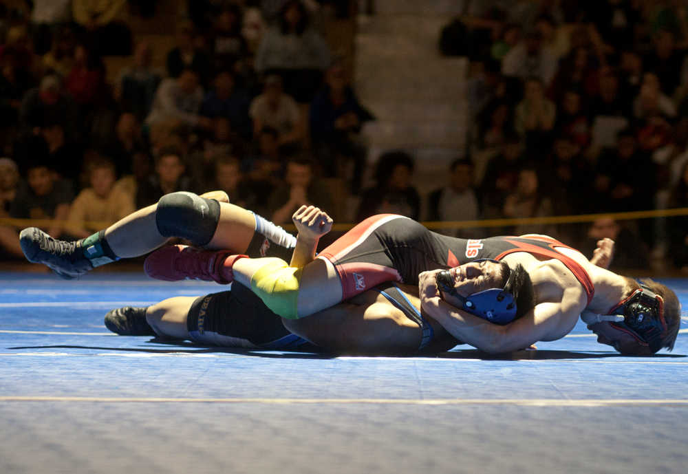 Photo by Rashah McChesney/Peninsula Clarion Paul Steffenson pins ... of Kodiak during their match Saturday Feb. 8, 2014 at Bartlett High School in Anchorage, Alaska.