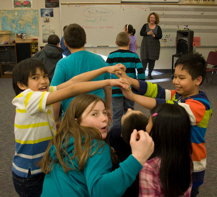Fourth-graders in Jeremy Peterson's Keet Gooshi Heen Elementary School class practice square dancing with instructor Susan Michaels, at rear, Monday Feb. 3, 2014, in Sitka, Alaska. Michaels is teaching line dancing and square dancing at the school as part of the Artist-in-Residence program. (AP Photo/Daily Sitka Sentinel, James Poulson)