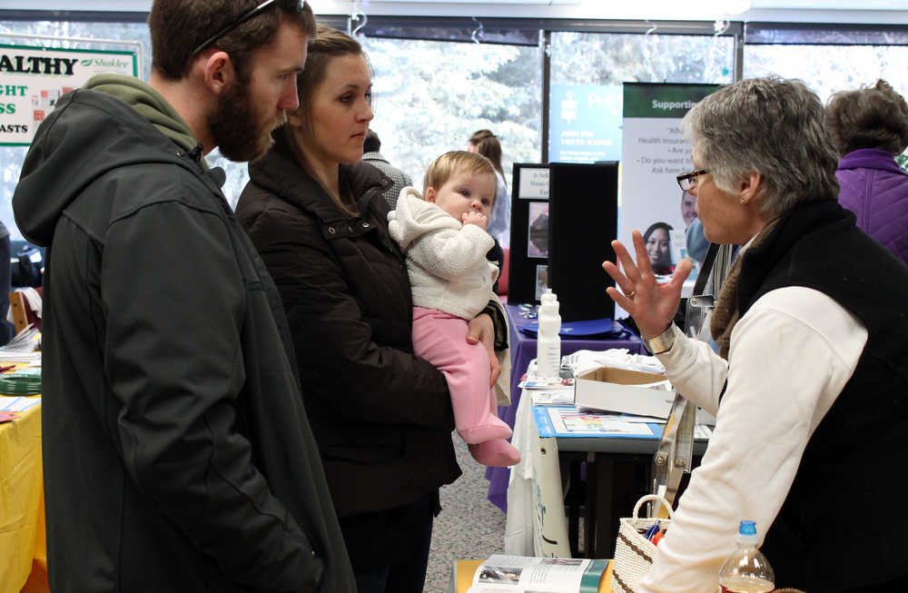 Photo by Dan Balmer Peninsula Clarion Tyler and Kelly Orender from Soldotna talk with volunteer about child safety at the Kenai Peninsula College Health Fair Wednesday afternoon. Orender received information on how to properly install child car seats for their infant daughter. Julia Vendetti, who volunteered at the blood drive, said approximately 100 people came to draw blood.