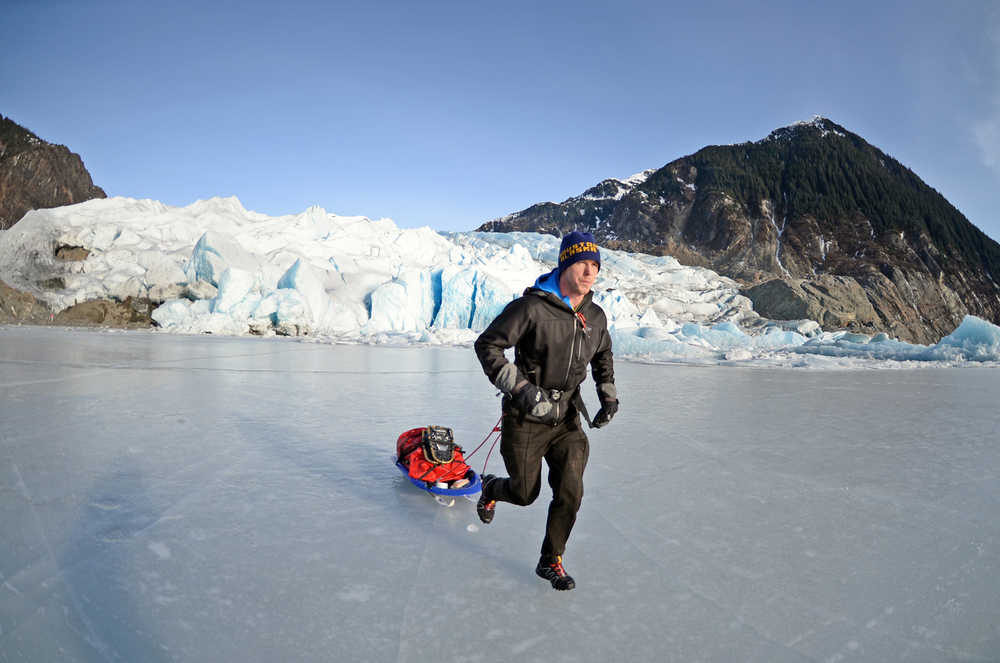 In this photo taken on Feb. 9, 2014, Houston Laws tows his recrafted sled across the ice at Mendenhall Lake near Juneau, Alaska, during a training run for the Susitna 100, a 100-mile ski, bike or run event that starts on Saturday, Feb. 15. It will be the first of four 100-mile races Laws hopes to complete in 2014 to achieve an Alaska ultrarunning "Grand Slam." The Alaska grand slam consists of the Susitna, the White Mountains 100, the Sluice Box 100 and the Resurrection Pass Trail 100.  (AP Photo/The Juneau Empire, Klas Stolpe)