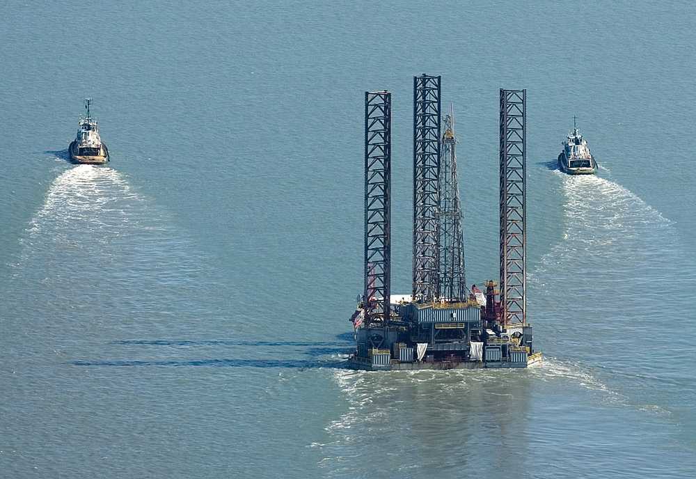 Peninsula Clarion file photo Tugs pull the Spartan 151 jack-up drilling rig up Cook Inlet in August 2011. New oil and gas development in the inlet, along with major projects planned for the area, could mean a boom for the Kenai Peninsula economy.