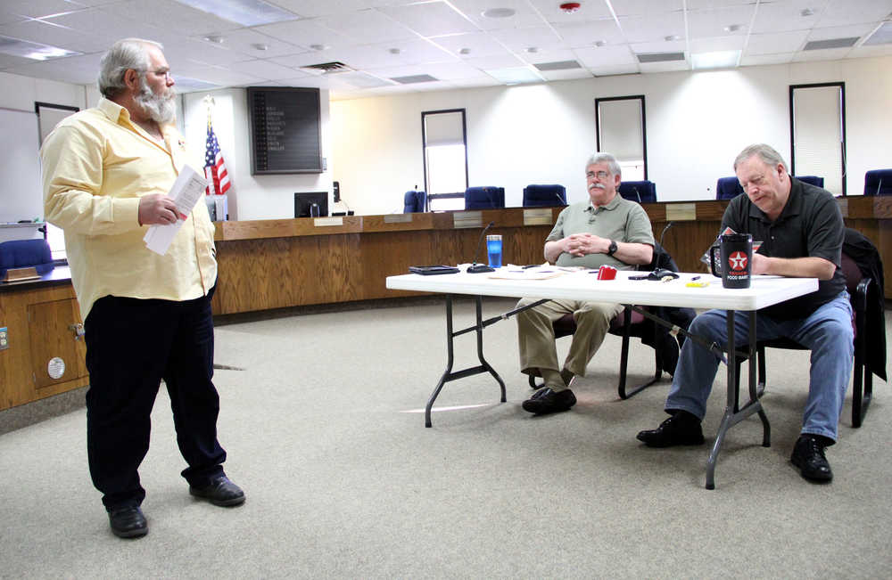 Reps. Kurt Olson, R-Kenai, and House Speaker Mike Chenault, R-Nikiski listen to David Caswell talk about making the Honor and Remember Flag a national symbol to recognize those who have died as a result of serving in the U.S. military. The representatives heard from a handful of central peninsula residents on Saturday at a town hall meeting in Soldotna. Photo by Kaylee Osowski/Peninsula Clarion