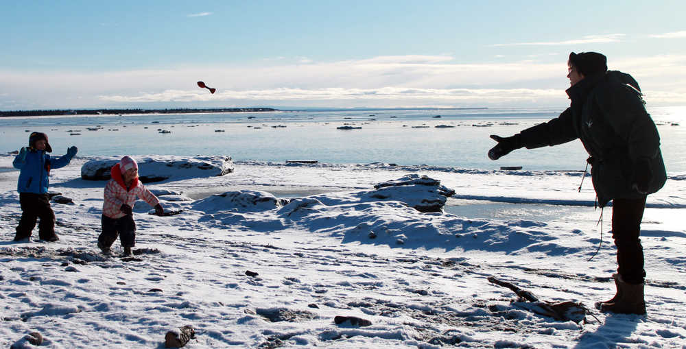 Photo by Dan Balmer/Peninsula Clarion Connie Moore from Ashford, Washington plays catch with her grandkids Eli and Mia Settlemyer (ages 4 and 2) at the north beach in Kenai Monday. Moore said she didn't expect weather like this in Alaska when she came up to visit. Light snow in the morning turned to partly sunny skies and a high temperature of 25 degrees Monday.