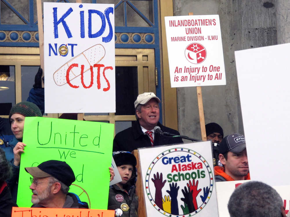 Mark Choate, a former Juneau school board member, addresses protestors on the steps of the state Capitol for a "Save Our Schools" rally to speak out against a proposed constitutional amendment that would allow public money to be used for private and religious schools on Monday, Feb. 17, 2014, in Juneau, Alaska. (AP Photo/Becky Bohrer)