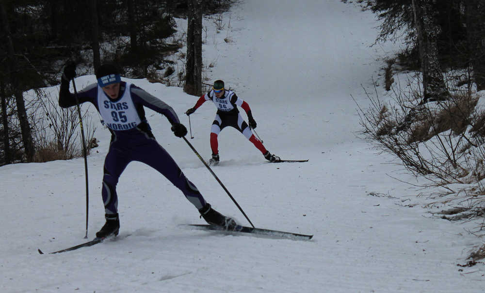 Photo by Jeff Helminiak Skyview's Brenner Musgrave leads Kenai Central's Travis Cooper up a hill near the start of the boys five-kilomter skate Friday at the Region III Nordic Ski Championships at Tsalteshi Trails on Friday.