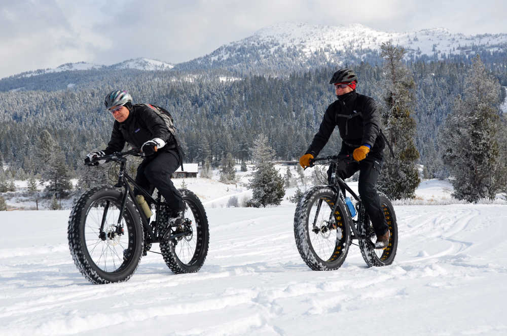 In this Feb. 6, 2014 photo, Steve and Kathy Muench ride the trails at Jug Mountain Ranch near McCall, Idaho. Fat bikes sport oversized balloon tires run at low air pressures that are specially designed to ride on packed snow and other surfaces. (AP Photo/The Idaho Statesman, Roger Phillips)