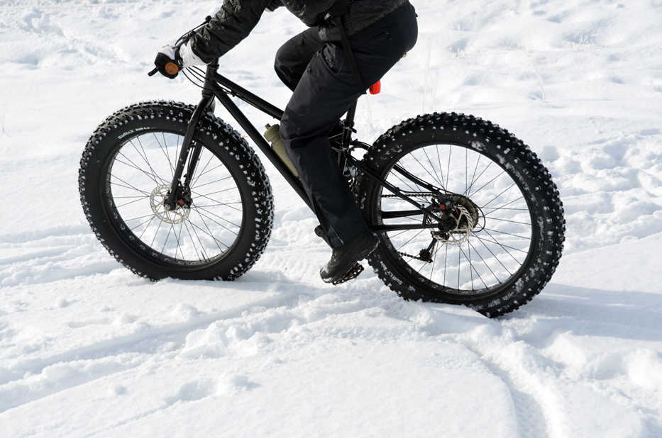In this Feb. 6, 2014 photo, fat tire bicycle rider travels the trails at Jug Mountain Ranch near McCall, Idaho. Fat bikes sport oversized balloon tires run at low air pressures that are specially designed to ride on packed snow and other surfaces. (AP Photo/The Idaho Statesman, Roger Phillips)