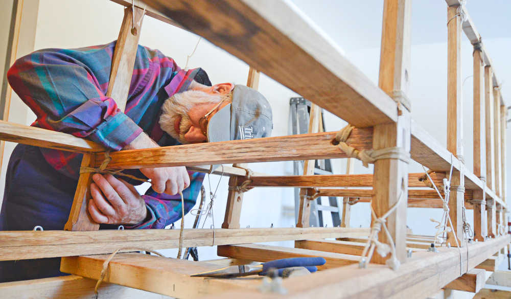 Photo by Rashah McChesney/Peninsula Clarion  Alan Perry works on a wooden Iditarod sled he and two companions are building for this year's race Thursday Feb. 20, 2014 in Kasilof, Alaska.