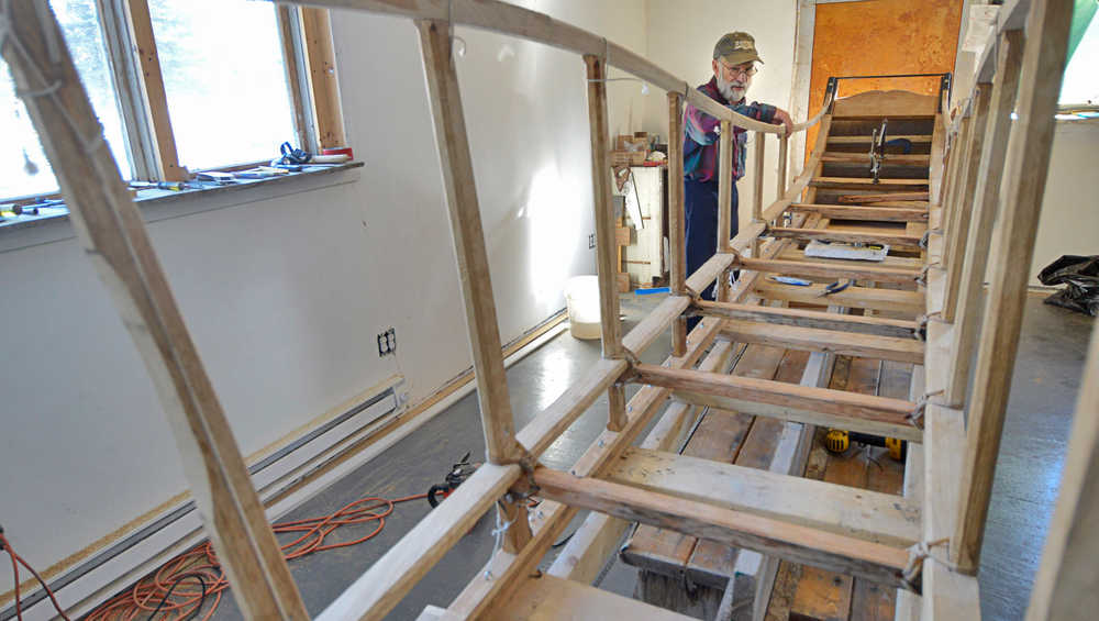 Photo by Rashah McChesney/Peninsula Clarion  Alan Perry stands near an Iditarod sled Thursday Feb. 20, 2014 that he is helping to build in Kasilof, Alaska. Perry and two companions are building the sled as a replica of those originally used to run freight along the Iditarod trail.