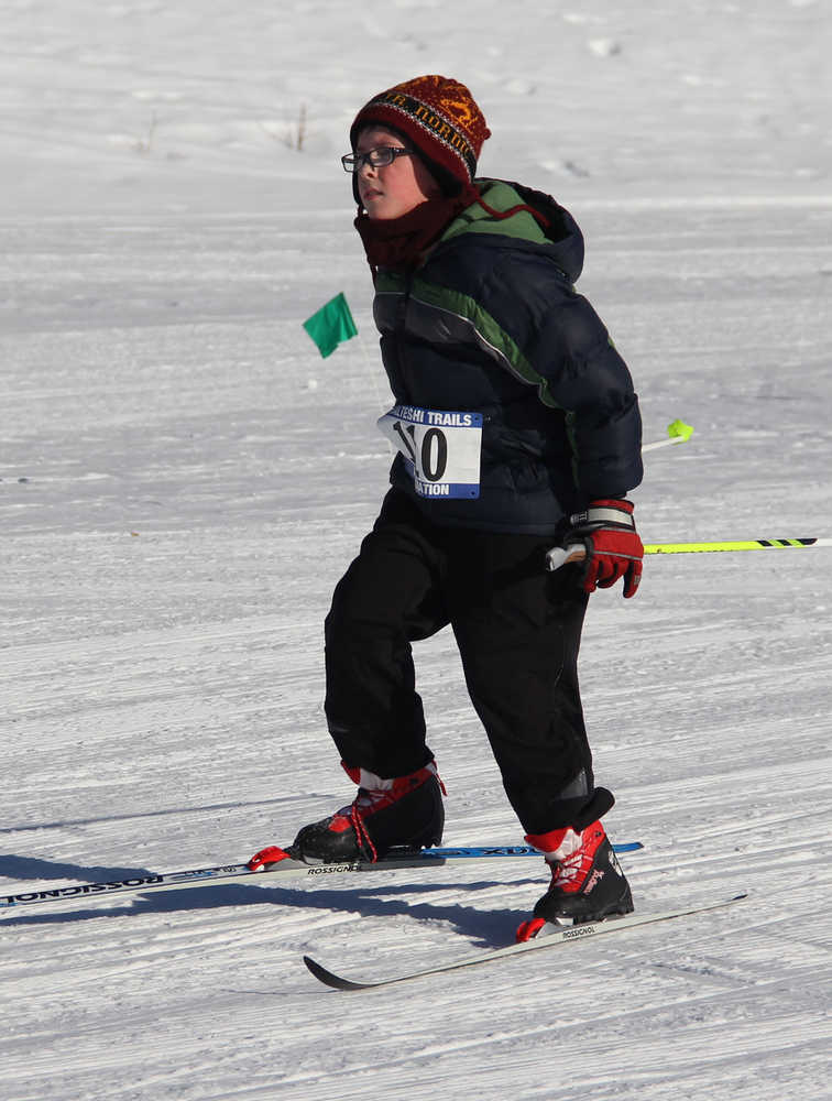 Photo by Dan Balmer/Peninsula Clarion Eleven year-old Gavin Brennan skis to the finish line in the Fuzzy Pretator 10K race Sunday at Tsalteshi Trails. Brennan said the race was hard on his legs, weary from skiing the day before, but was determined to finish and had a lot of fun.