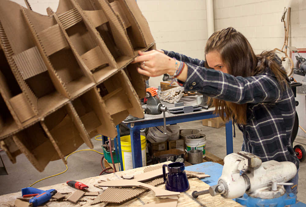 Photo by Rashah McChesney/Peninsula Clarion  Chelsea Springer, freshman, works on a cardboard form for her sculpture class Wednesday Feb. 26, 2014 at Kenai Peninsula College Kenai River Campus in Soldotna, Alaska.