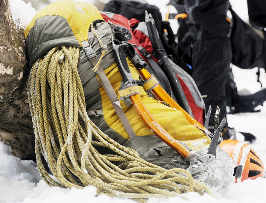 In this Feb. 9, 2014 photo, an ice climber's gear sits beside a log at the bottom of the icefall inside Wildcat Canyon at Starved Rock State Park new Utica, Ill. Climbers pack snacks, water and ropes that are up to 500 feet long. The ropes are made especially for ice climbing, and climbers only use them one time, due to fraying and tension. (AP Photo/NewsTribune, Scott Anderson)