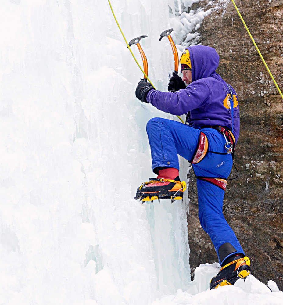 In this Feb. 9, 2014 photo, David Siemk of Morton Grove, Ill., uses hatchets and spiked shoes called "crampons" while ice climbing at the more than 100-foot-tall Wildcat Canyon icefall at Starved Rock State Park new Utica, Ill. The shoes are generally composed of 10 steel spikes pointing down for traction and two pointing forward to stab and hold in vertical ice. (AP Photo/NewsTribune, Scott Anderson)