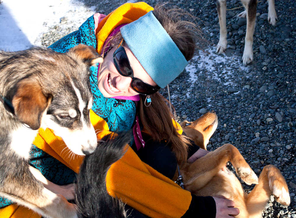 Photo by Rashah McChesney/Peninsula Clarion  Monica Zappa, of Ninilchik plays with three of her sled dogs Tuesday Feb. 25, 2014 in Kenai, Alaska. Zappa plans to race her team on the Iditarod Trail Sled Dog Race for the first time this year.