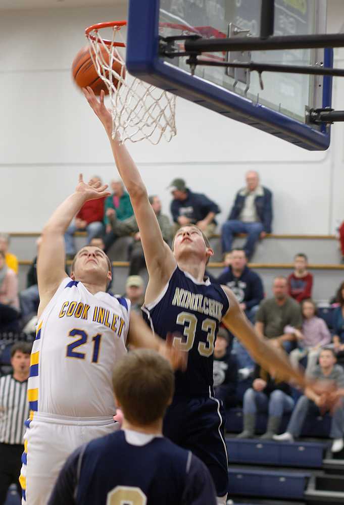 Photo by Rashah McChesney/Peninsula Clarion  Cook Inlet Academy's Riley Smithwick watches Ninilchik's Austin White slap a shot away from the basket during their game Thursday Feb. 27, 2014 in Soldotna, Alaska.