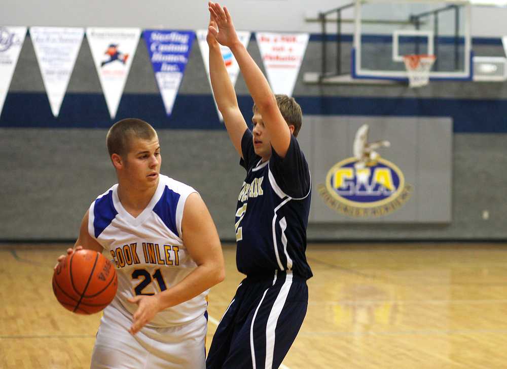 Photo by Rashah McChesney/Peninsula Clarion  Cook Inlet Academy's Riley Smithwick looks for an opening to pass during their game against Ninilchik Thursday Feb. 27, 2014 in Soldotna, Alaska.