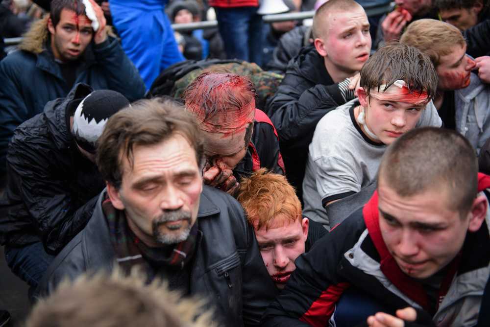 Pro-Western activists sit after being overpowered by pro-Russia activists after clashes at the local administration building in the northeastern city of Kharkiv, Ukraine, Saturday, March 1, 2014. Supporters of new Ukrainian authorities and pro-Russia demonstrators clashed in Kharkiv, a mostly Russian-speaking region in eastern Ukraine. (AP Photo/Olga Ivashchenko)