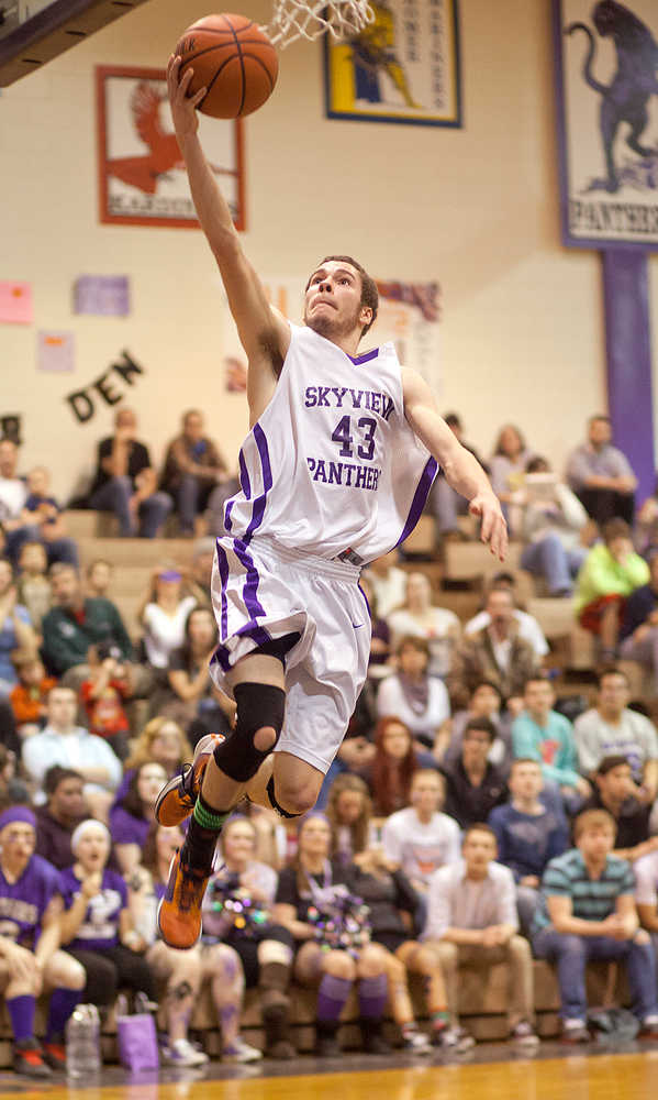 Photo by Rashah McChesney/Peninsula Clarion  Skyview's Micah Hilbish goes in for a layup during their game against Homer Friday Feb. 28, 2014 in Soldotna, Alaska.