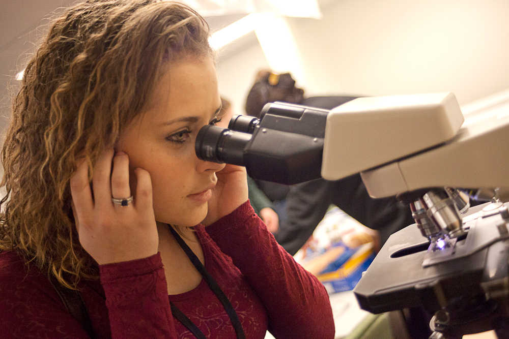 Photo by Rashah McChesney/Peninsula Clarion  Zykiah Cooney, sophomore at Nikiski High School, looks at blood cells under a microscope during a career day event at Central Peninsla Hospital Tuesday Feb. 25, 2014 in Soldotna, Alaska.